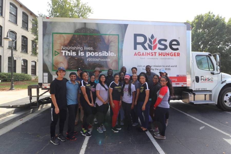 a group of RAH volunteers standing in front of a truck